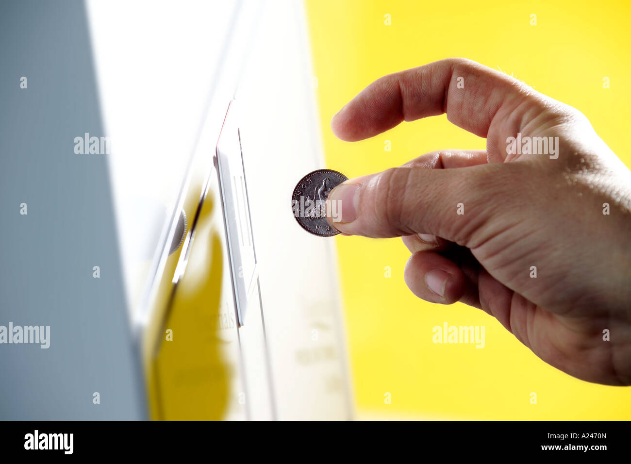 Coin operated vending machine hand feeding coin Yellow studio