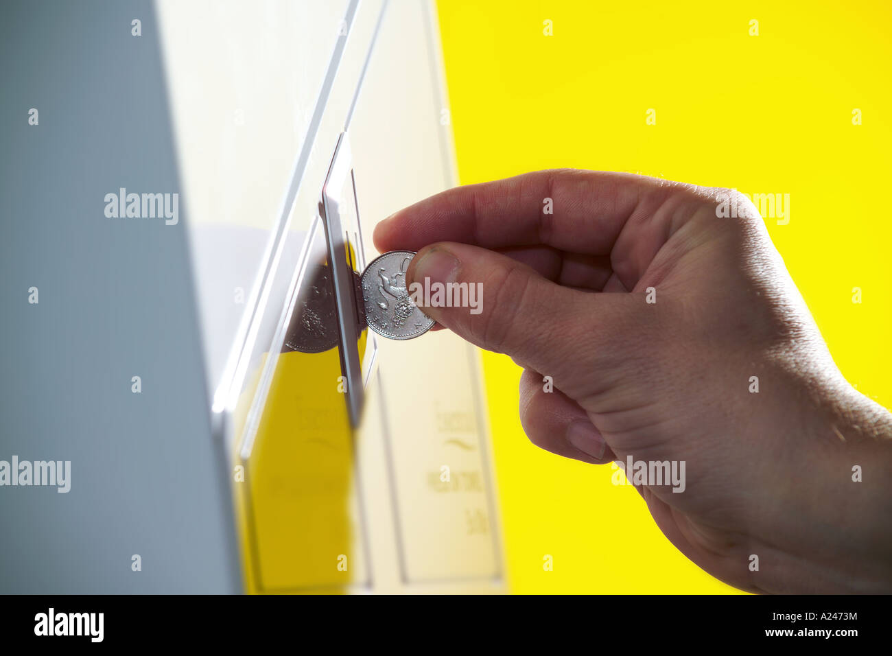 Coin operated vending machine hand feeding coin Yellow studio