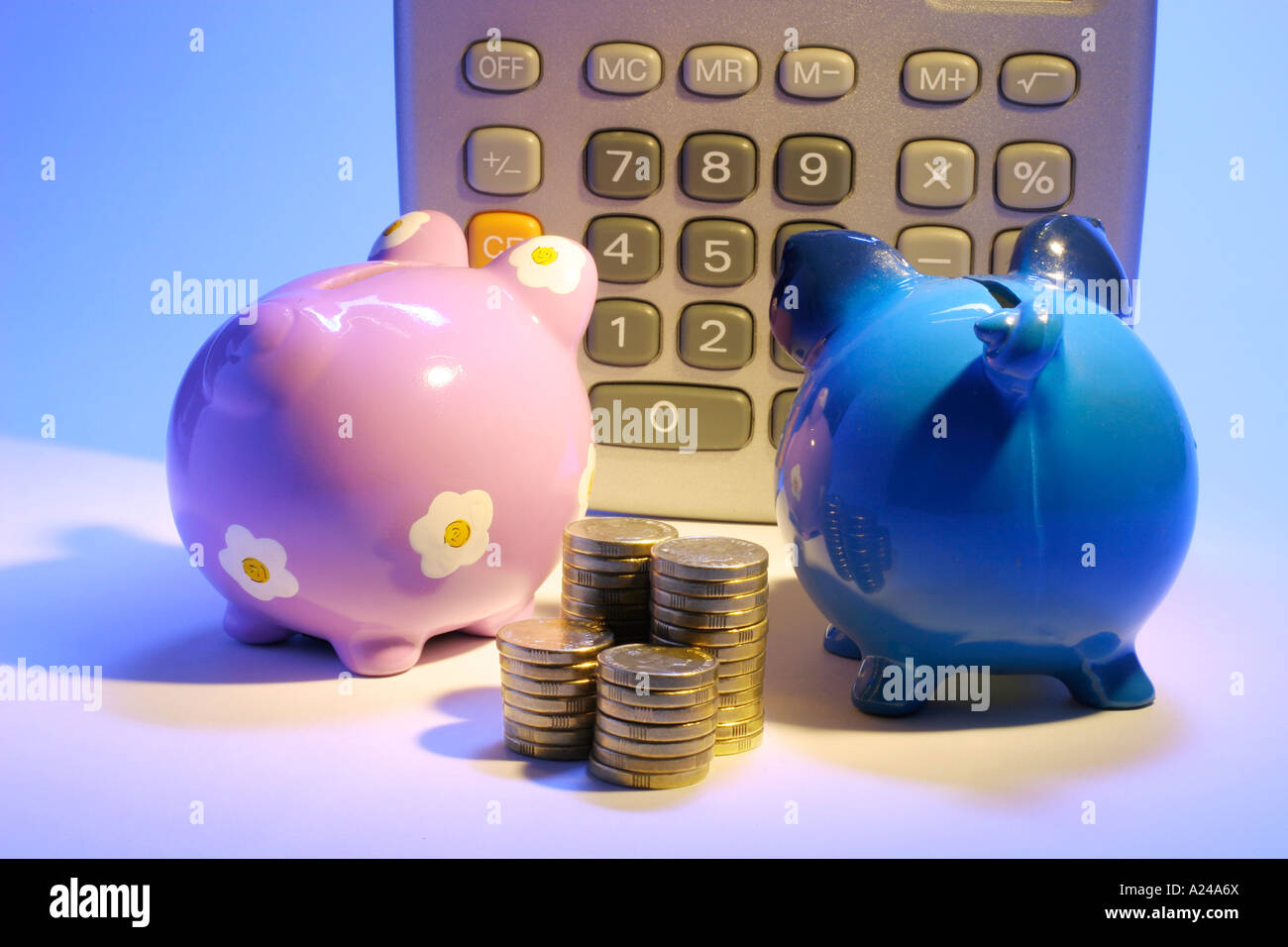 Calculator with Piggybanks and Coins Stock Photo - Alamy