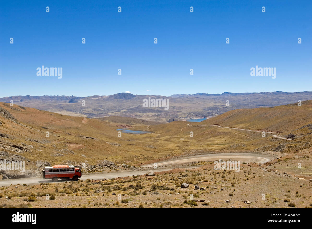 An overland adventure holiday truck driving on a dirt road through the rugged landscape scenery of Peru. Stock Photo