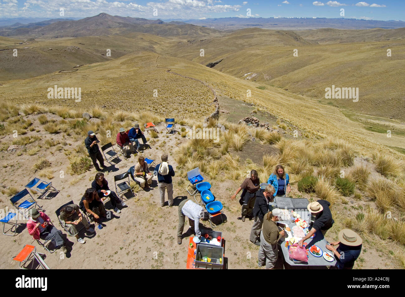 An overland adventure truck stops by the side of the road so that the passengers can take a break and lunch with great scenery. Stock Photo