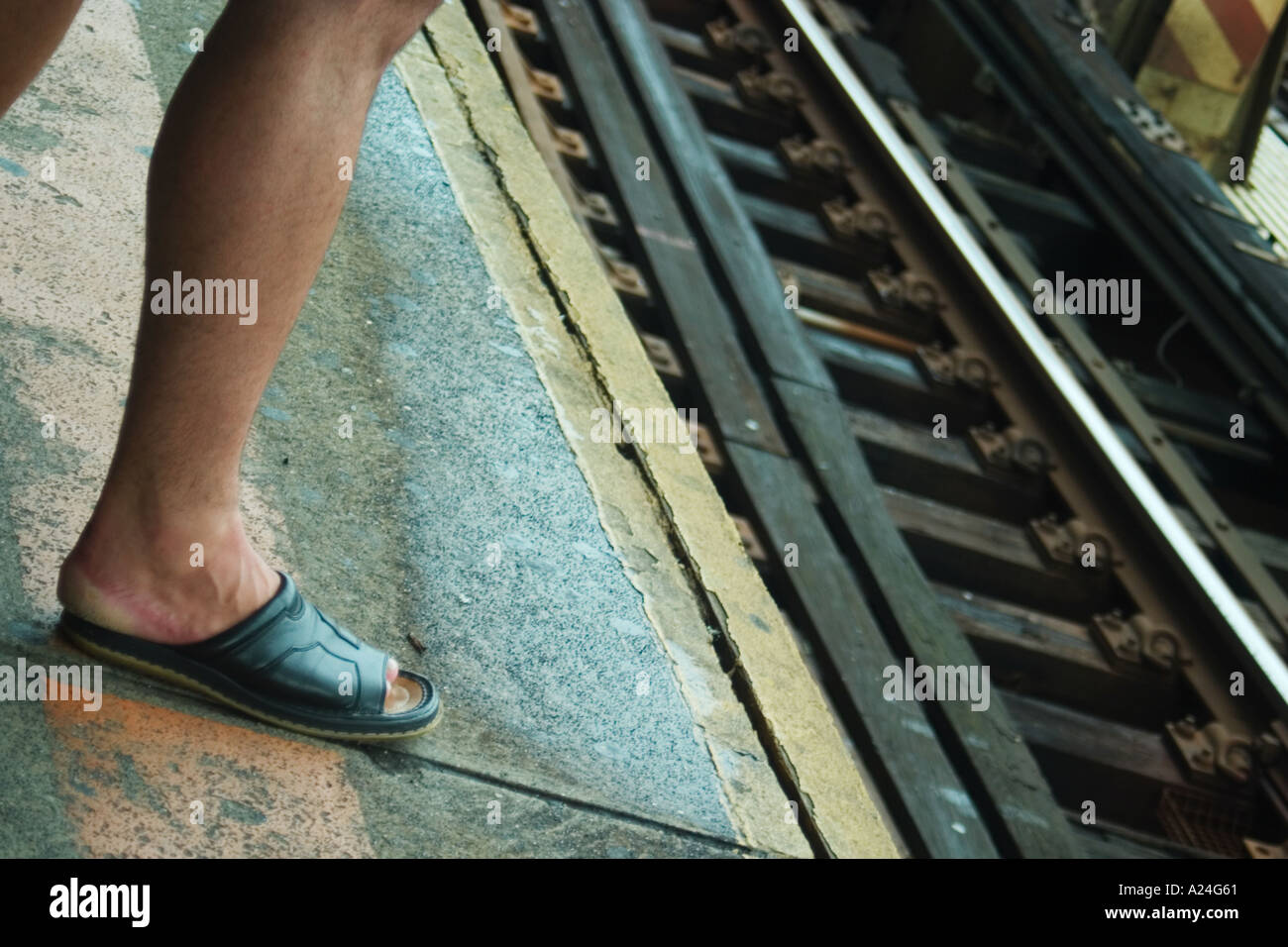 Man s foot near train tracks Stock Photo Alamy