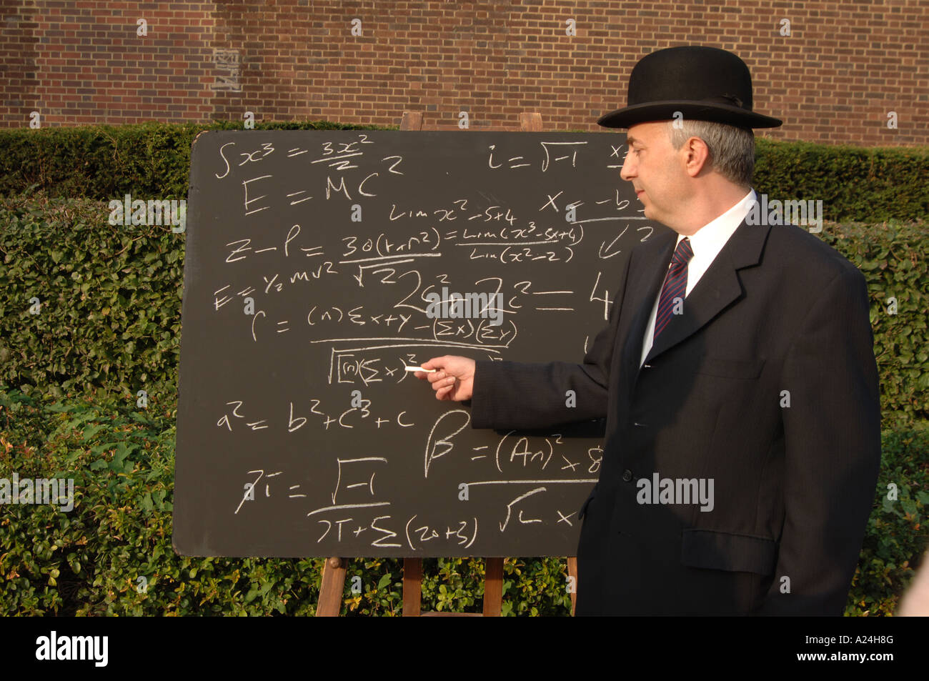 City gent with complicated mathematical formula on a blackboard Stock Photo