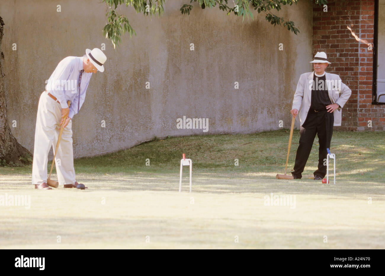 Croquet game players in Victorian Dress Lawn Grass Hoop Ball Mallet Man
