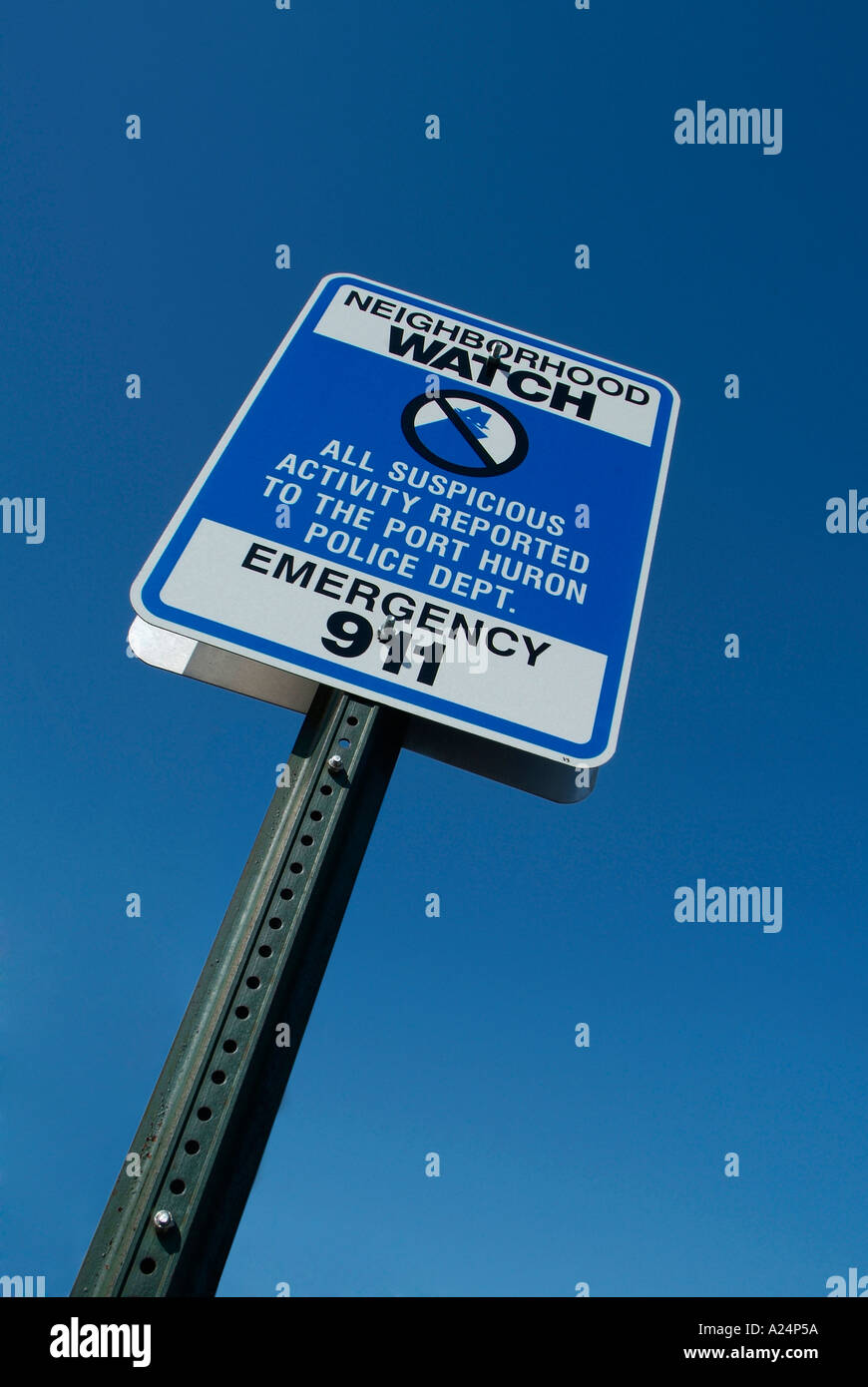 Neighborhood watch sign advises suspicious activity to be reported to 911 police Stock Photo