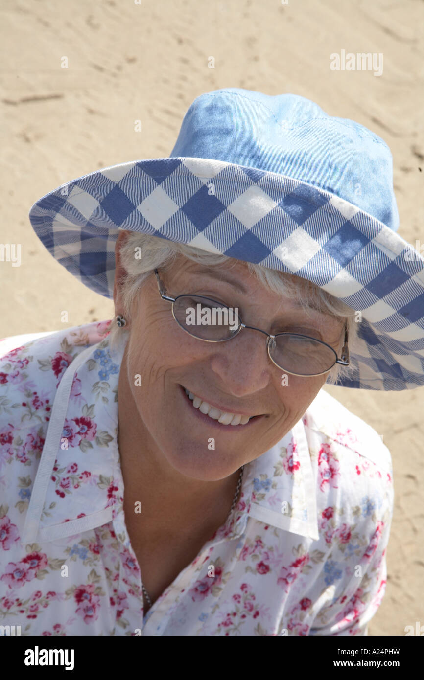 mature lady in hat on the beach enjoying the summer Stock Photo - Alamy