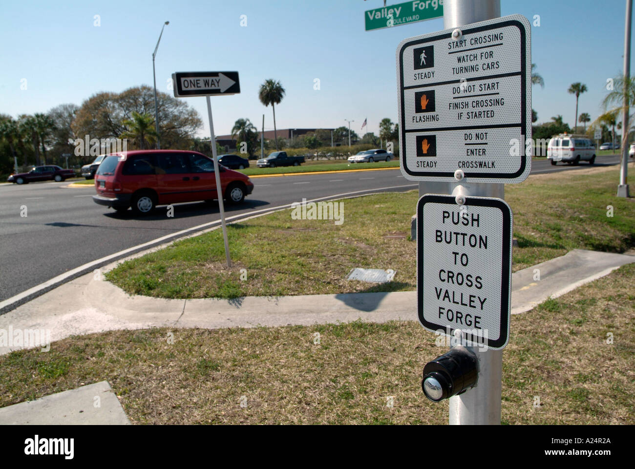 Instructions and directions on how to cross the street at a busy intersection Stock Photo Alamy
