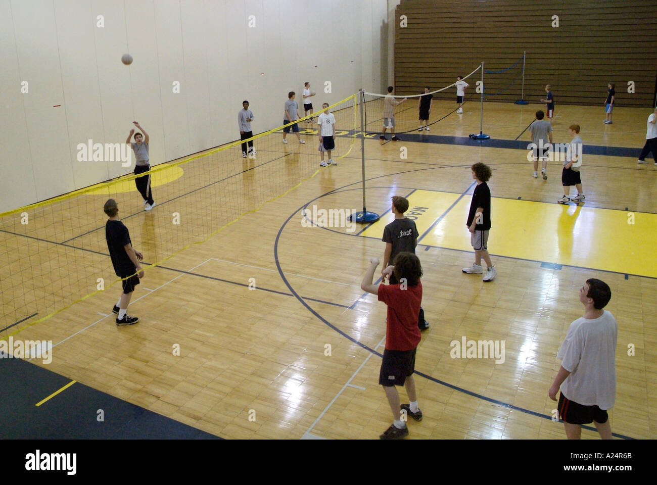 Students play volleyball in gym class Stock Photo Alamy