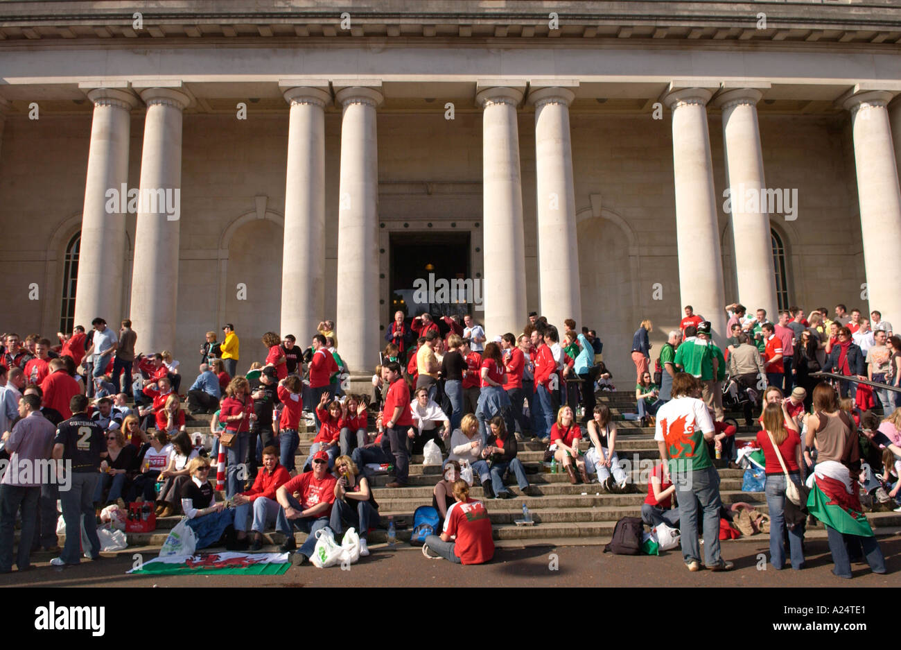 Welsh rugby fans outside in Cardiff celebrating a Six Nations Championship Grand Slam match win against Ireland Stock Photo