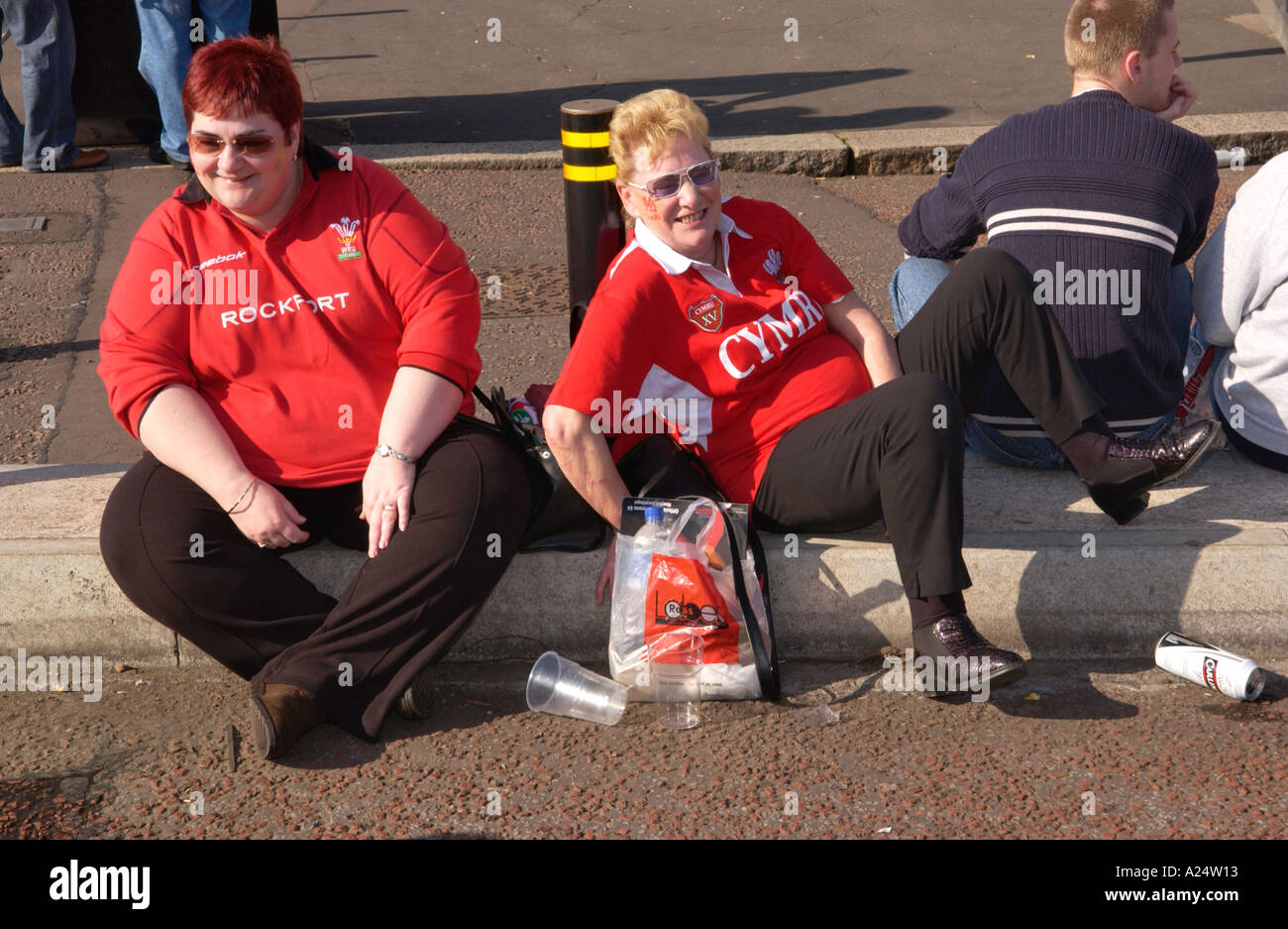 Welsh rugby fans outside in Cardiff celebrating a Six Nations Championship Grand Slam match win against Ireland Stock Photo