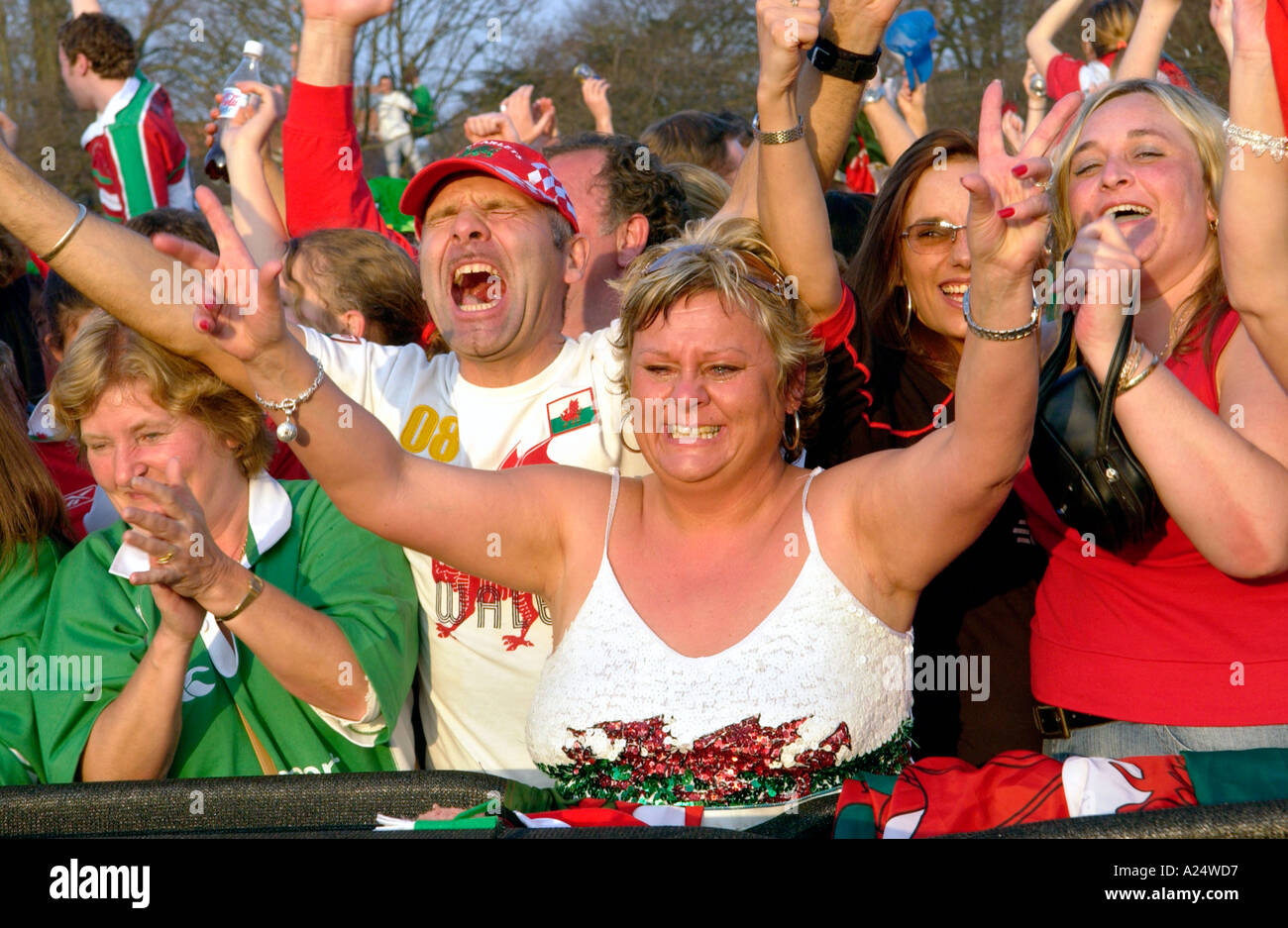 Female Welsh rugby fans celebrate Wales winning an international match in Cardiff South Wales UK Stock Photo