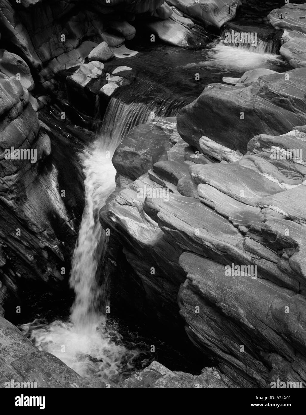 Waterfall, winding river between steep eroded rocks Stock Photo
