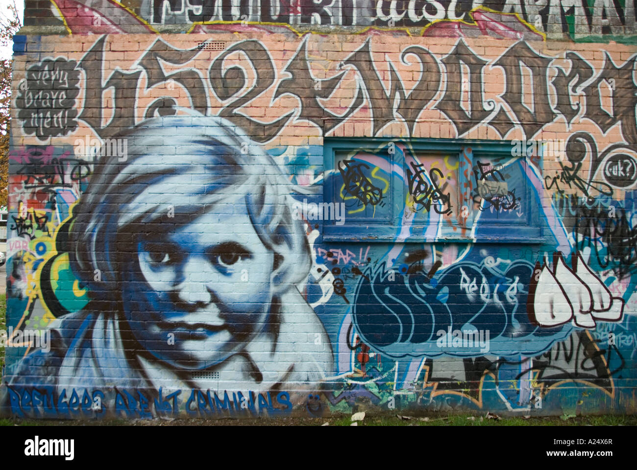 Blue White Boy s Face Head Painted on Graffiti Wall Manzil Way, Oxford, UK Stock Photo