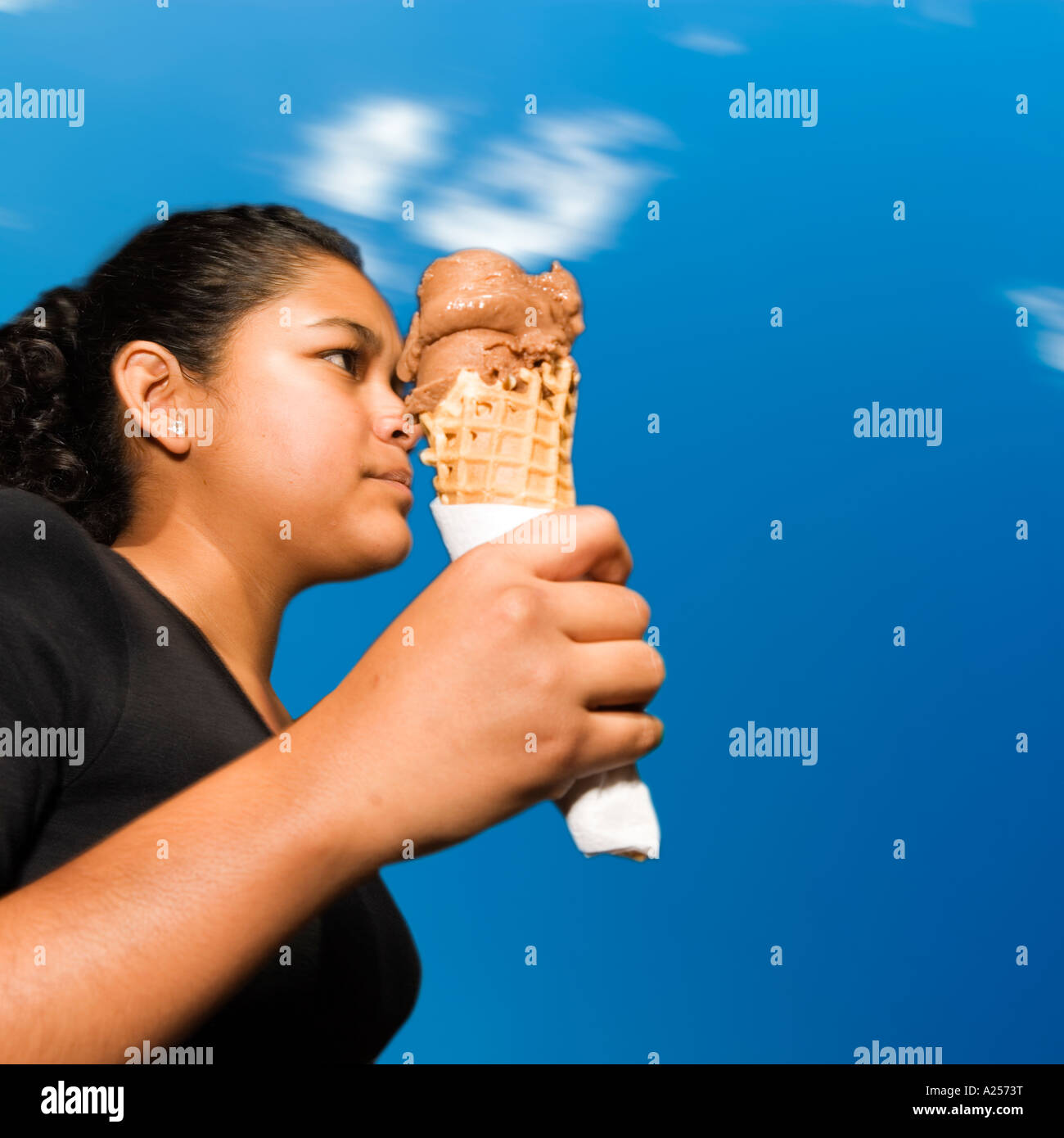 Girl walking by eating ice-cream on the streets of downtown Mazatlan Mexico Stock Photo