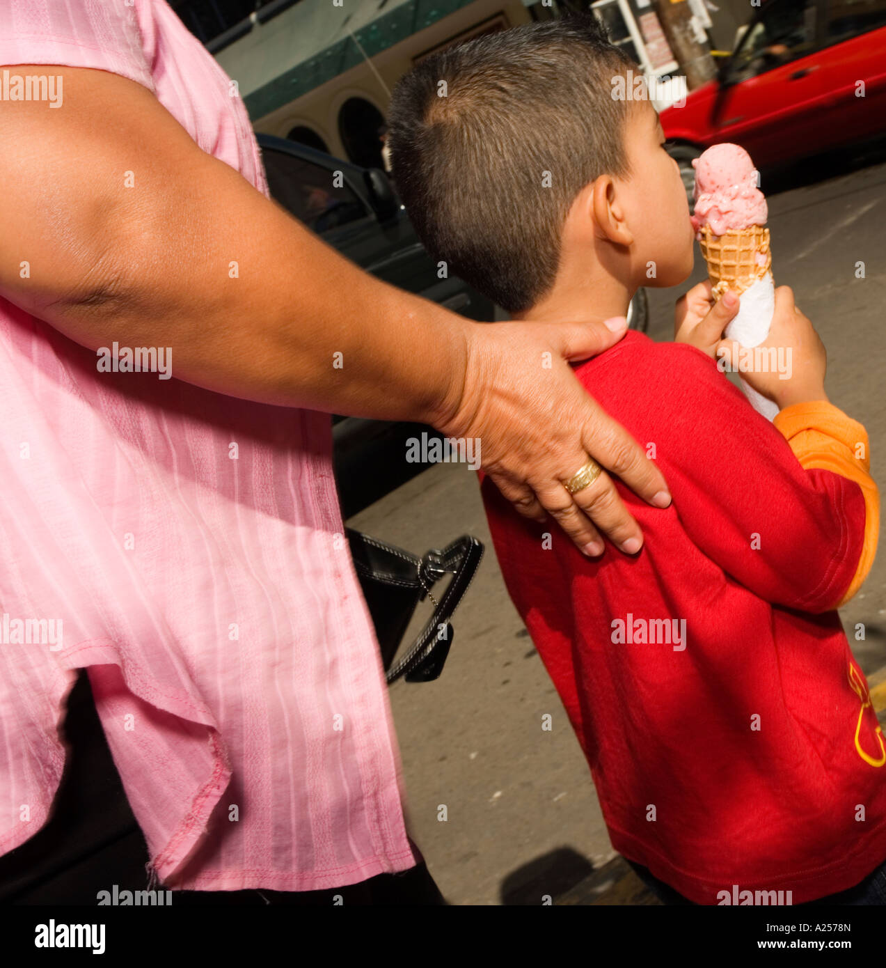 Boy eating ice-cream mexico No release required as crop, back side view means all features unrecognizable Stock Photo