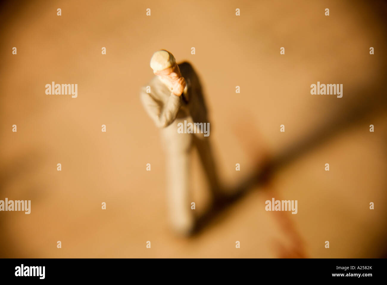 Miniature businessman with hand on chin standing on financial newspaper Stock Photo