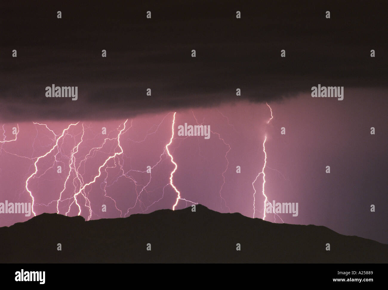 LIGHTNING IN DARK SKY OVER HILLS MOUNTAIN Stock Photo - Alamy