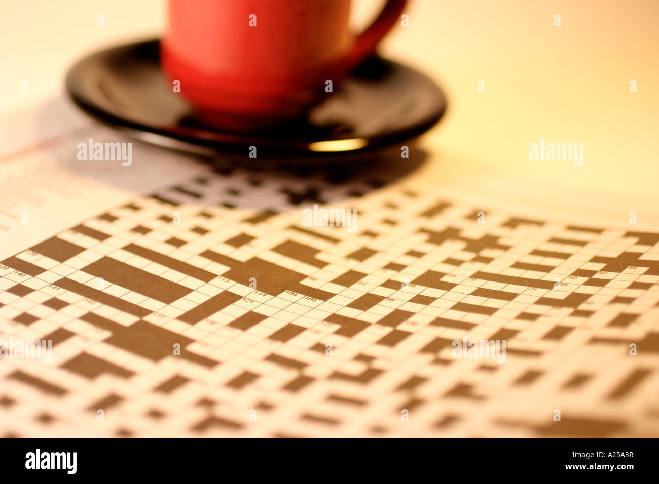 Teacup on Saucer with Crossword Puzzle Stock Photo Alamy