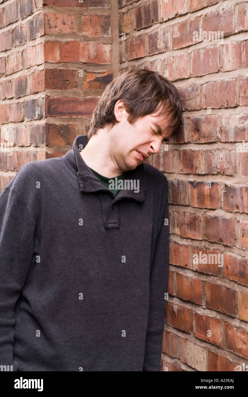 Banging Head Against Wall High Resolution Stock Photography and Images