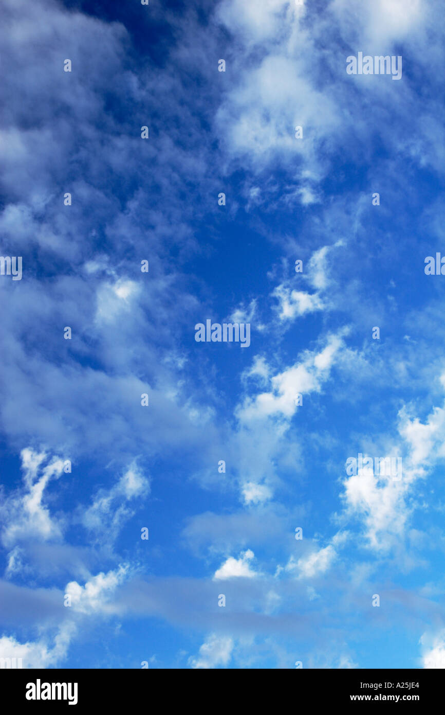 Blue sky with wispy white clouds background Stock Photo - Alamy