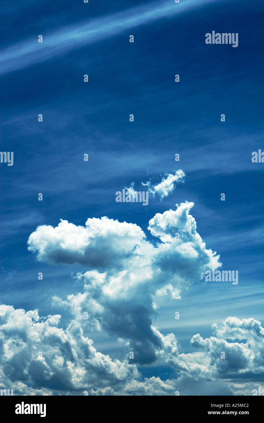 Blue sky with wispy white clouds background Stock Photo - Alamy