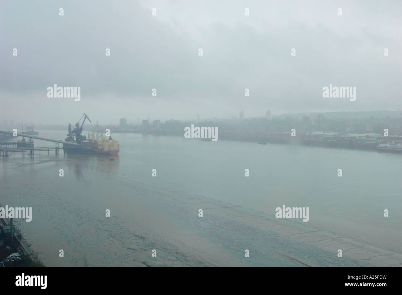 view of foggy murky misty river thames from tradewinds apartment london