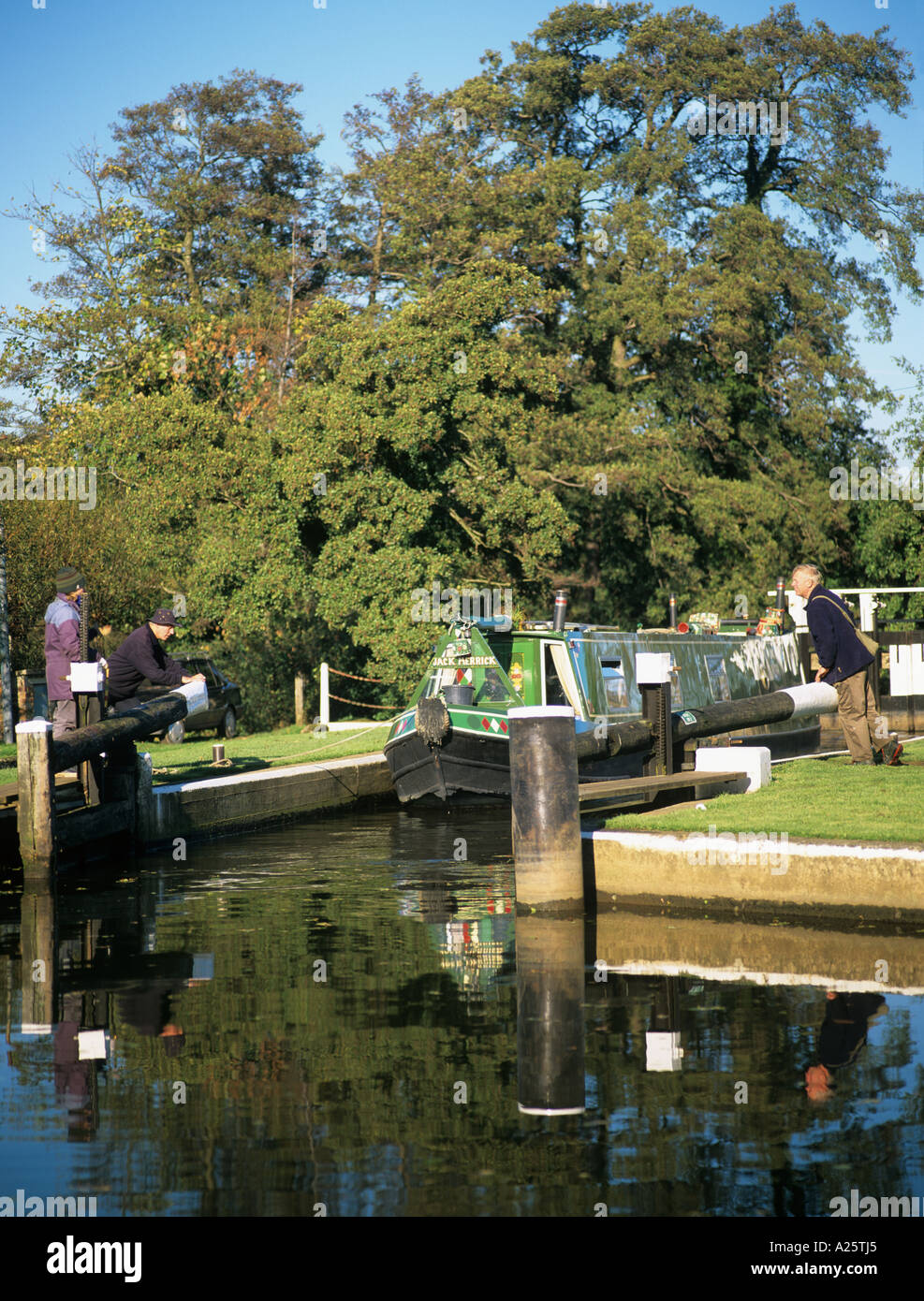 GREEN CANAL NARROWBOAT in TRIGG'S LOCK with gates open on Wey Navigation.  Sutton Green Surrey England UK Britain Stock Photo