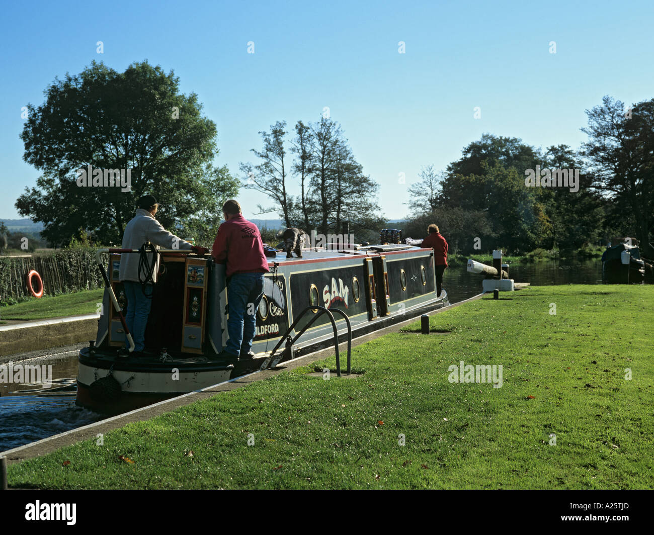 CANAL NARROW BOAT in TRIGG'S LOCK travelling south on Wey Navigation.  Sutton Green Surrey England UK Stock Photo