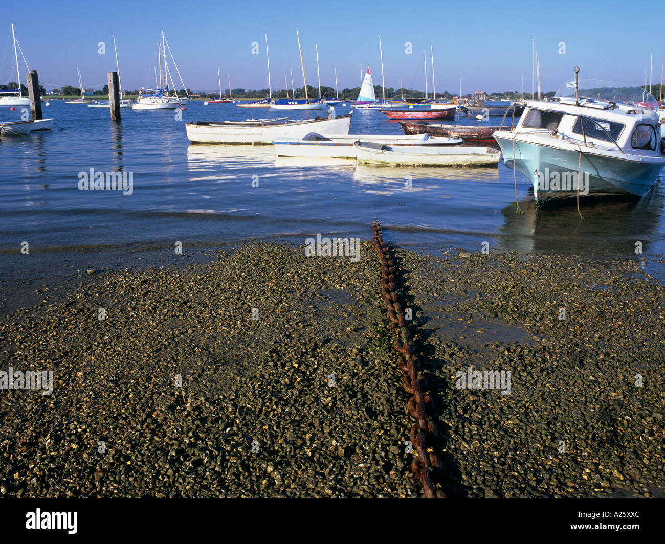 RUSTY CHAIN and MOORED DINGHIES on the shingle beach in Chichester