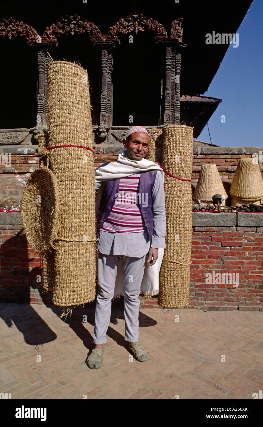 A Nepali man carries hand woven matts Pattan Nepal Stock Photo
