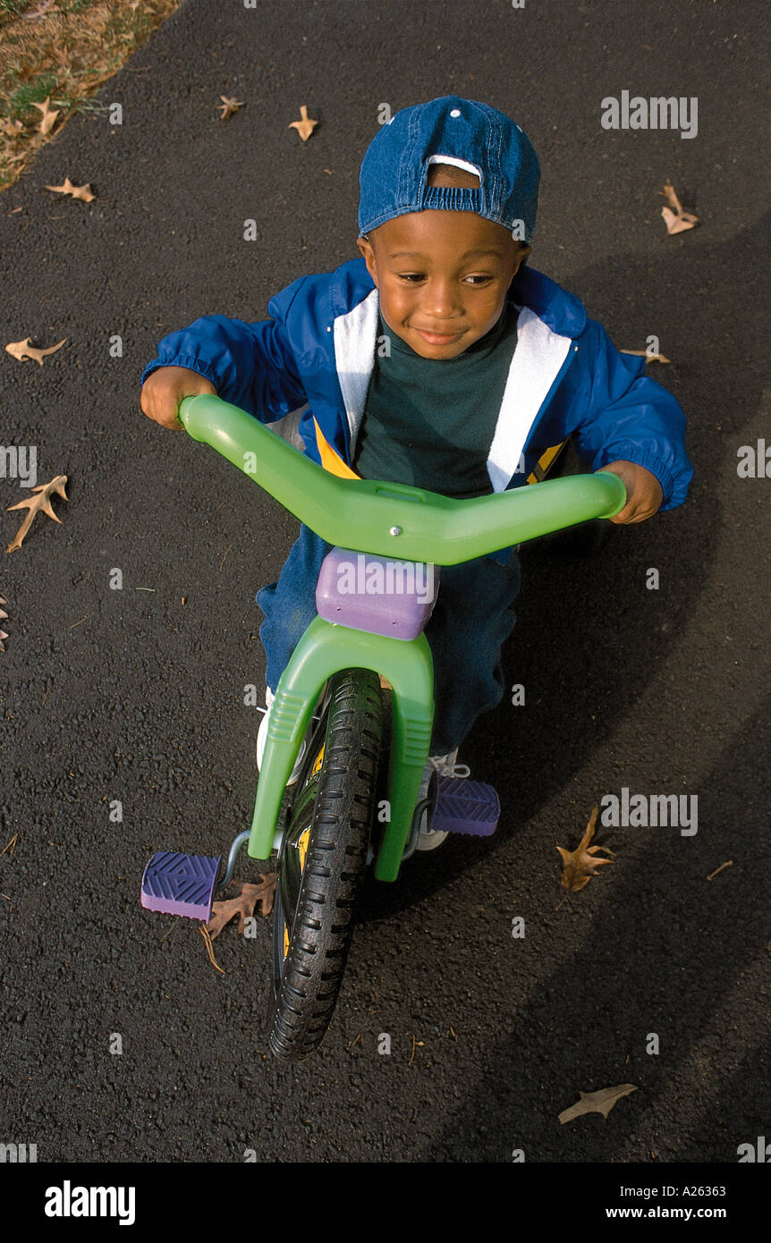 YOUNG BOY RIDING TRICYCLE Stock Photo Alamy