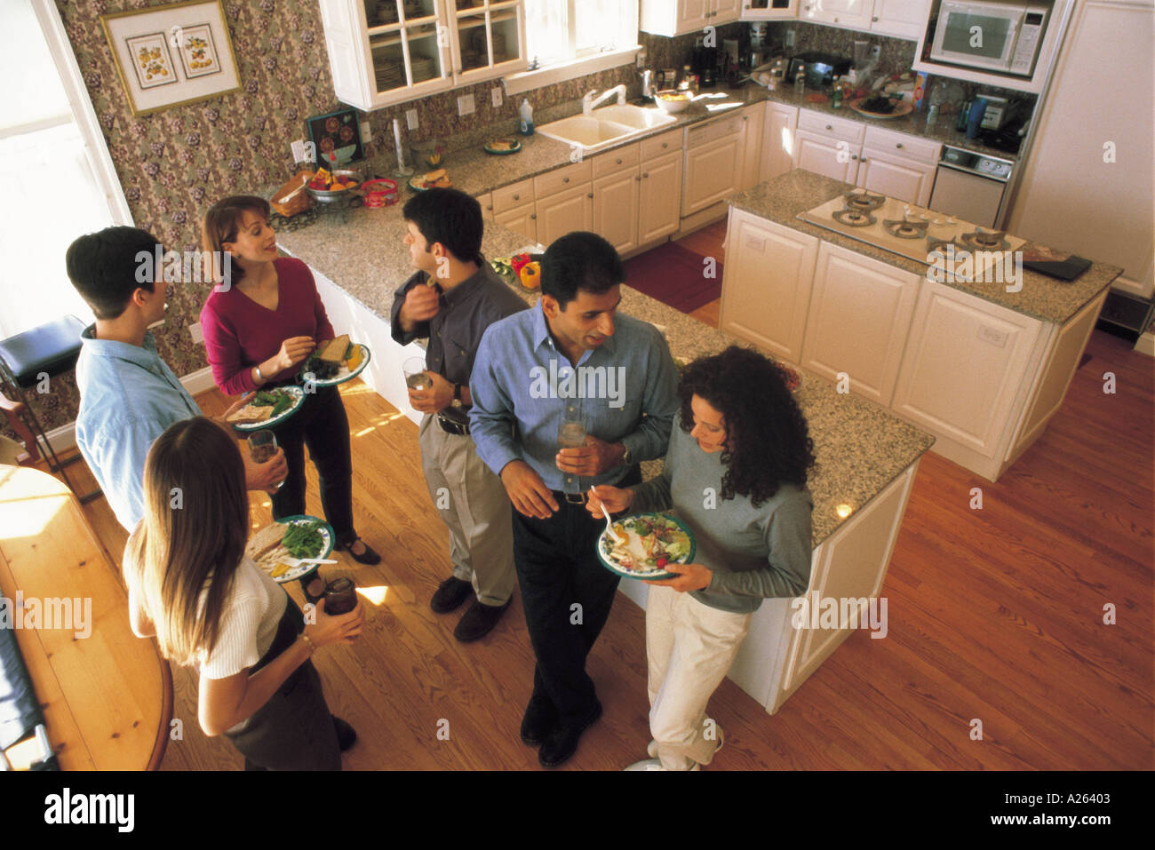 Birdseye View Of People Standing In Kitchen Eating Stock Photo Alamy