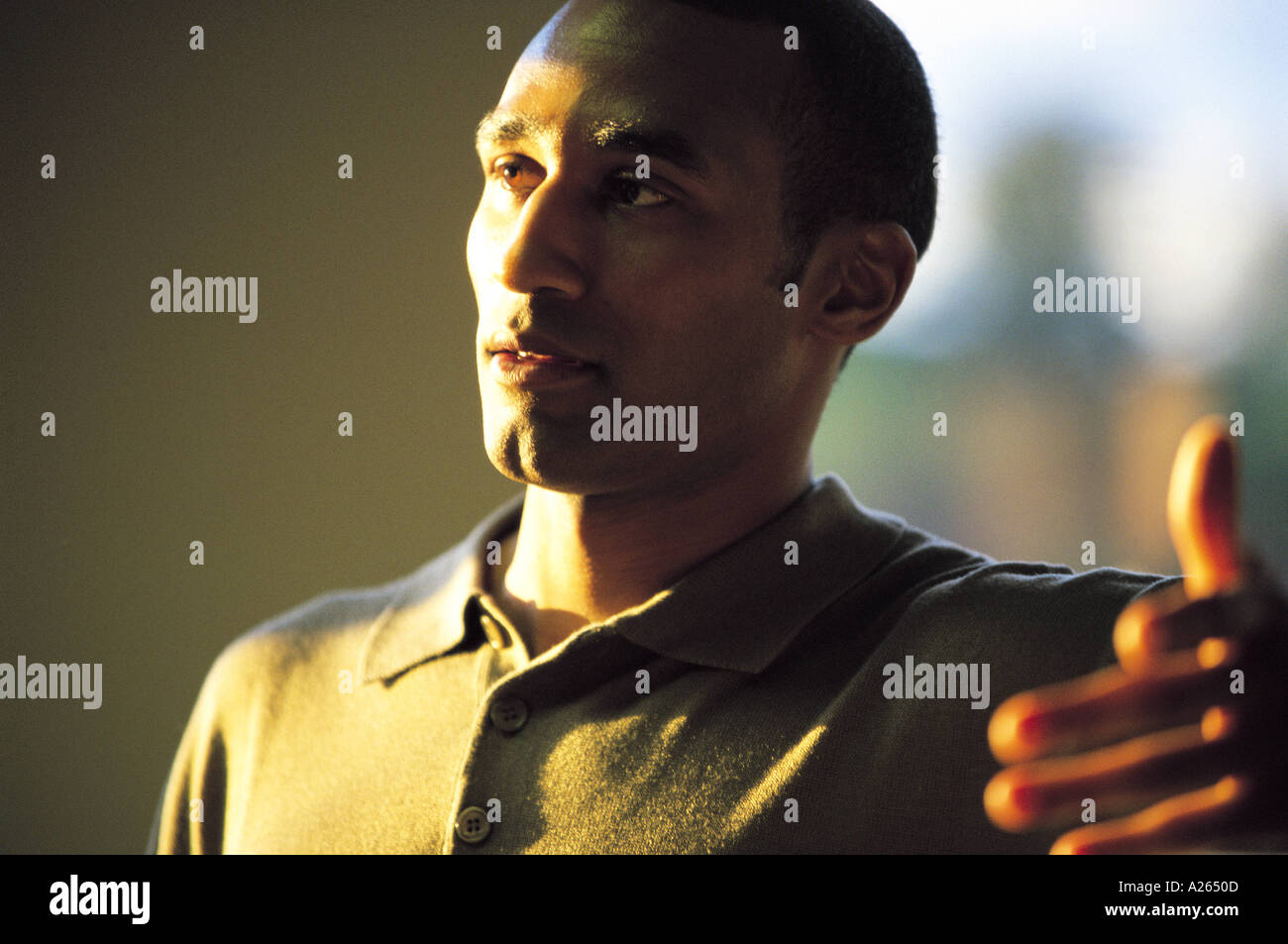 PORTRAIT OF MAN HALF IN THE SHADE Stock Photo