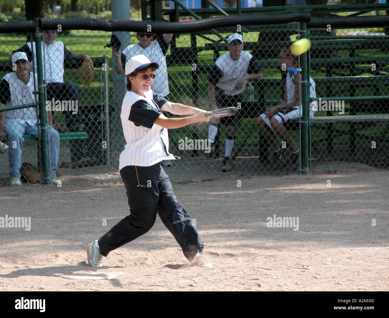 Female hits a softball Stock Photo Alamy
