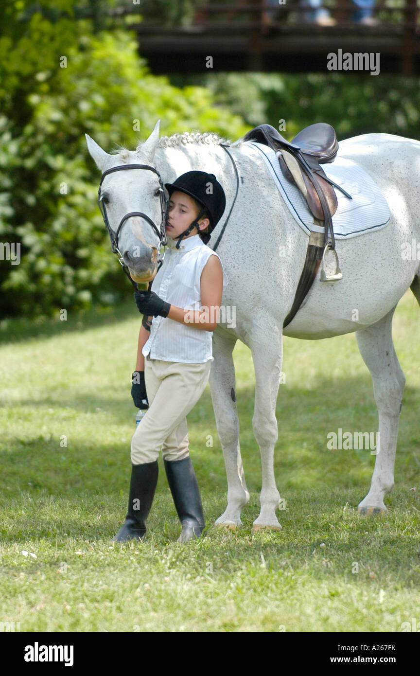 Ten year old girl preparing to ride a horse in an equestrian event Stock Photo - Alamy