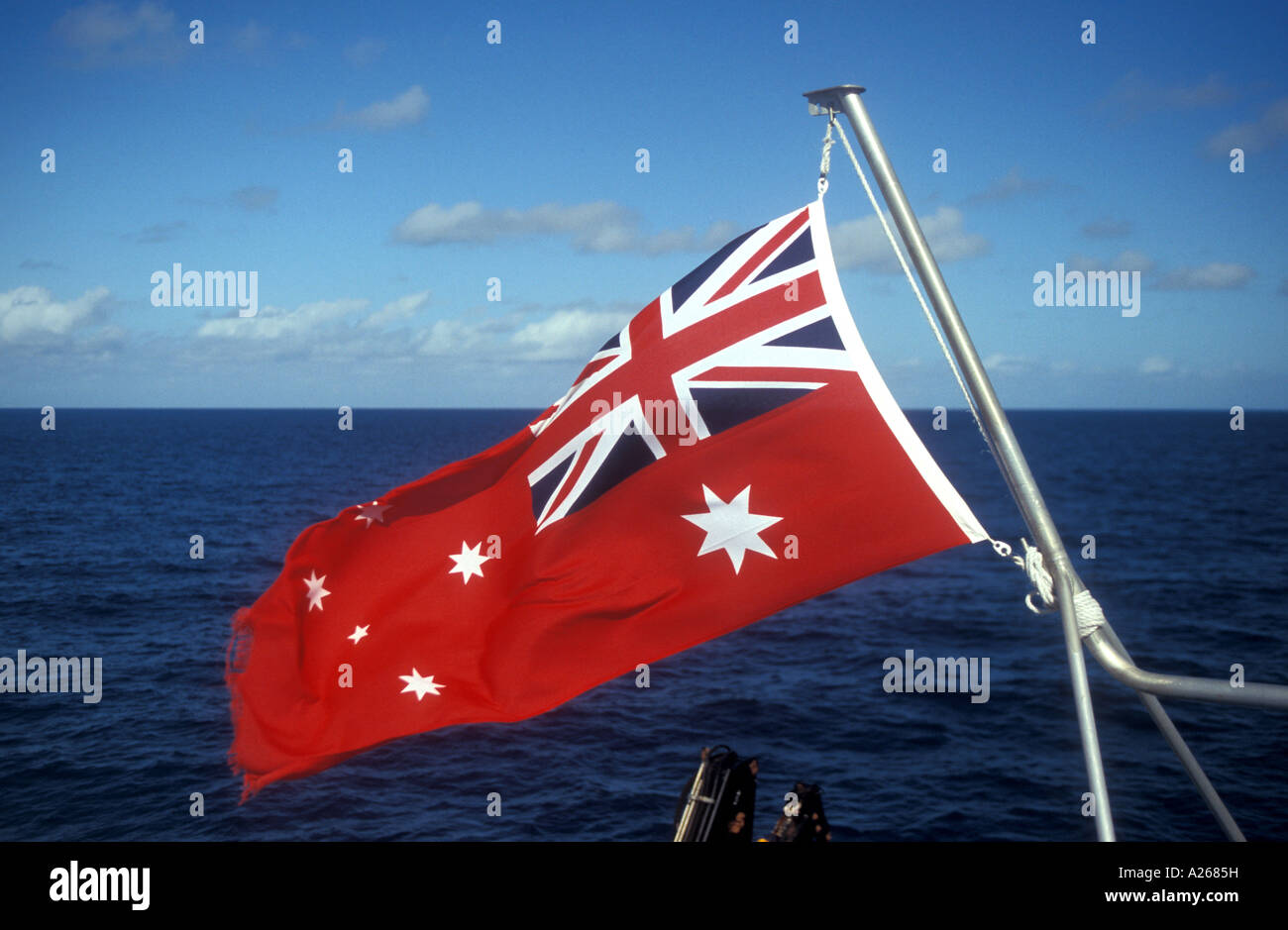 Australian red ensign flag on Great Barrier Reef catamaran Quicksilver VIII taking tourists to base at Agincourt Reef. Stock Photo