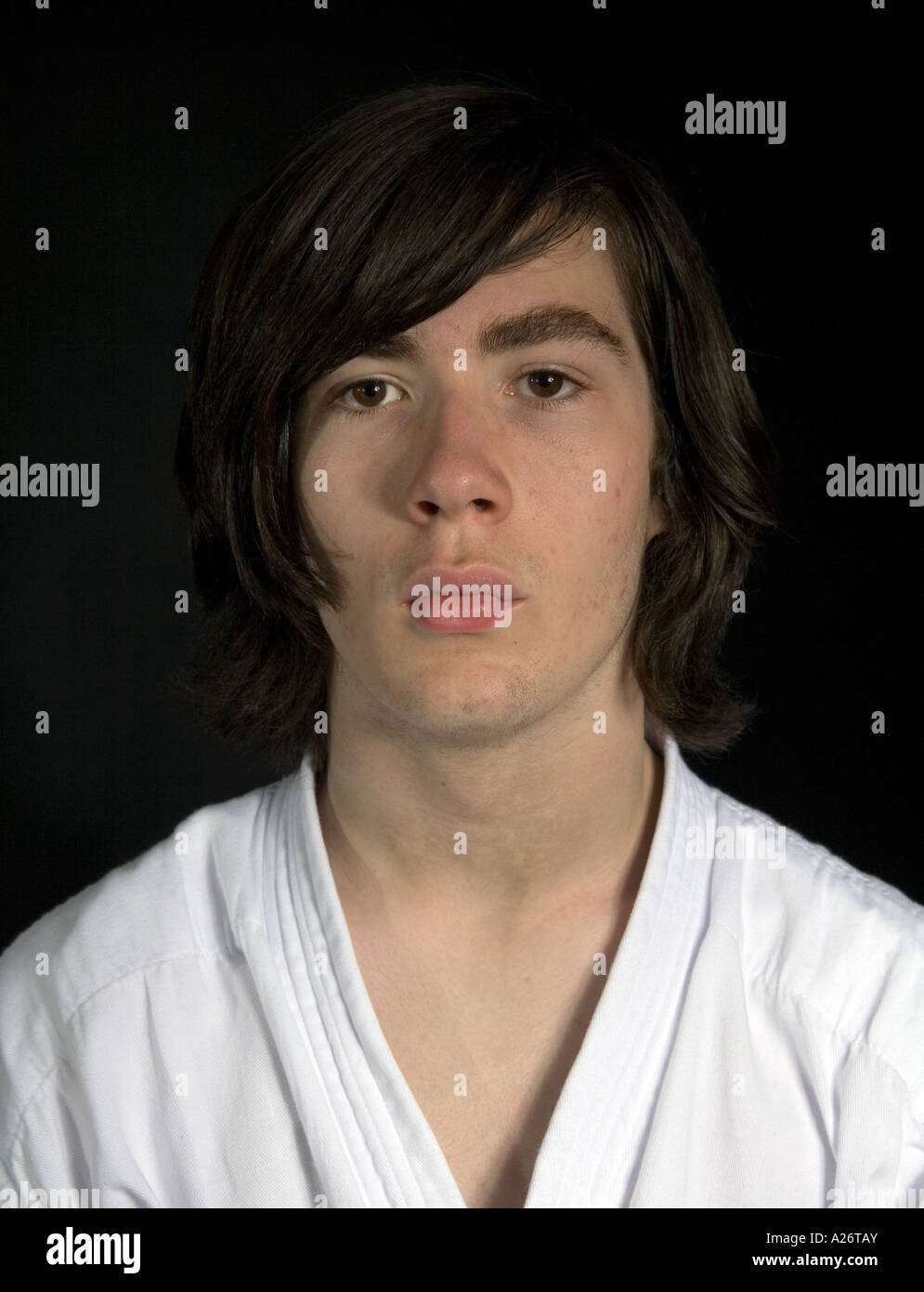 Young Man With Long Shoulder Length Hair Looking Straight At The