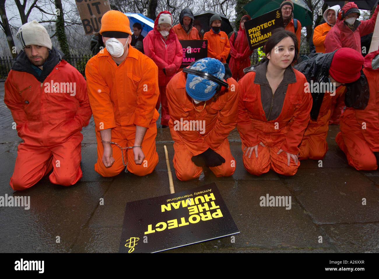 Amnesty International protesters wearing orange boiler suits Stock Photo