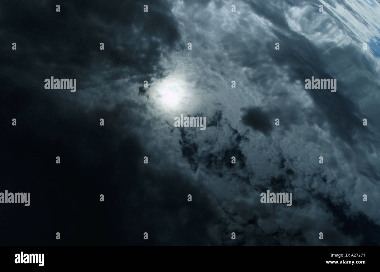 Clouds and sun reflecting in the sea Stock Photo - Alamy