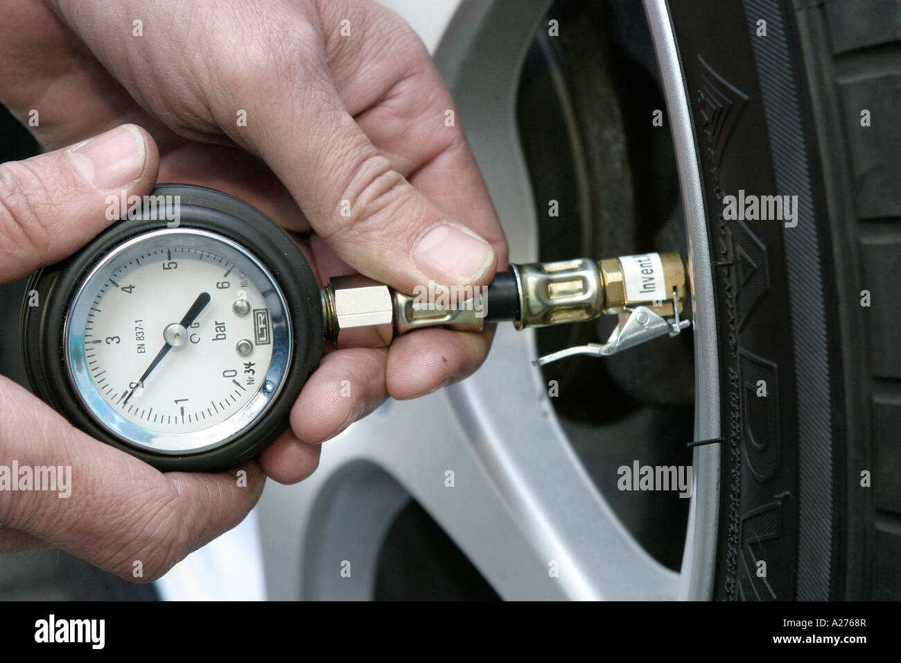 Checking tyre pressures on car hires stock photography and images Alamy