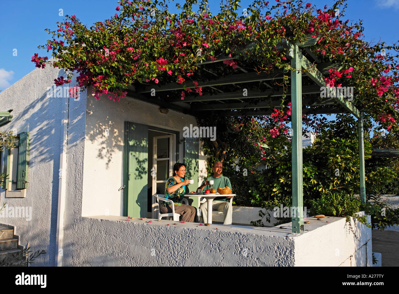 Pair having breakfast in Apartments Glaros near Palekastro, eastern Crete, Greece Stock Photo