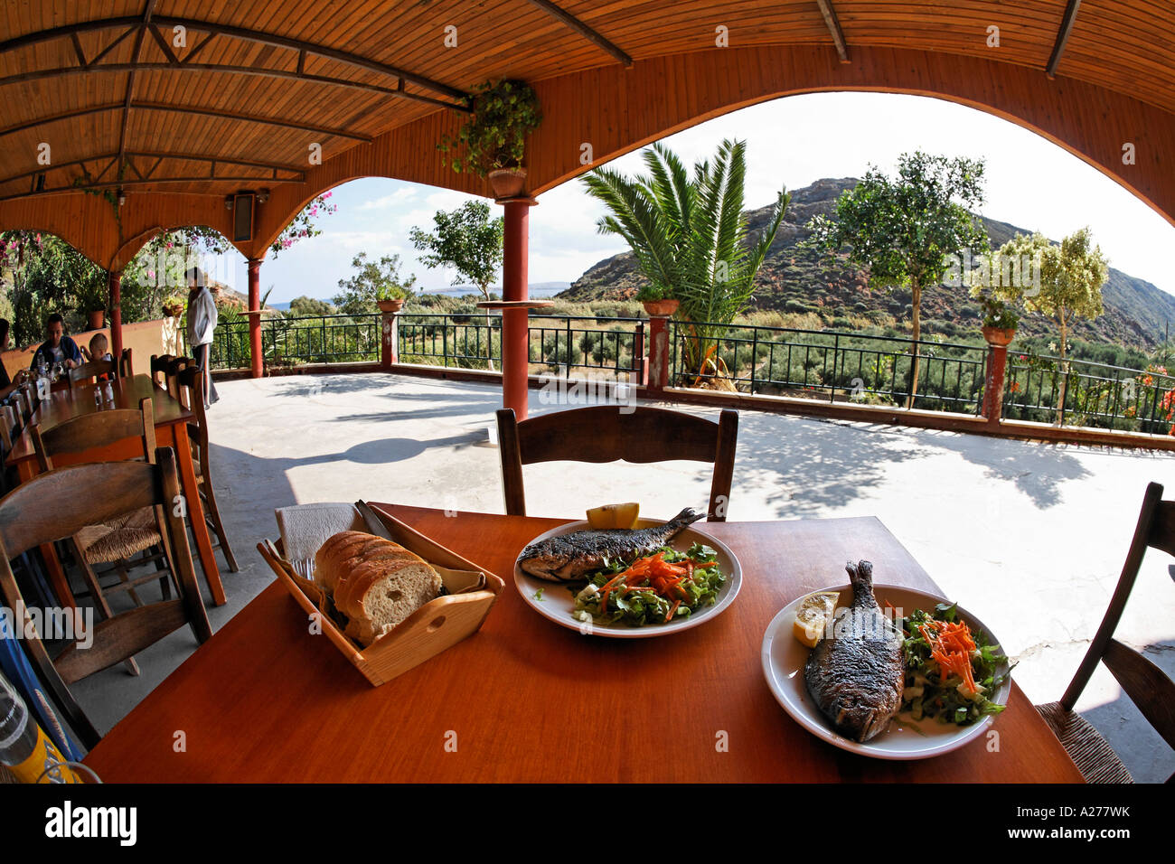Gilthead seabream with salad in tavern Maridati near Palekastro, Crete, Greece Stock Photo
