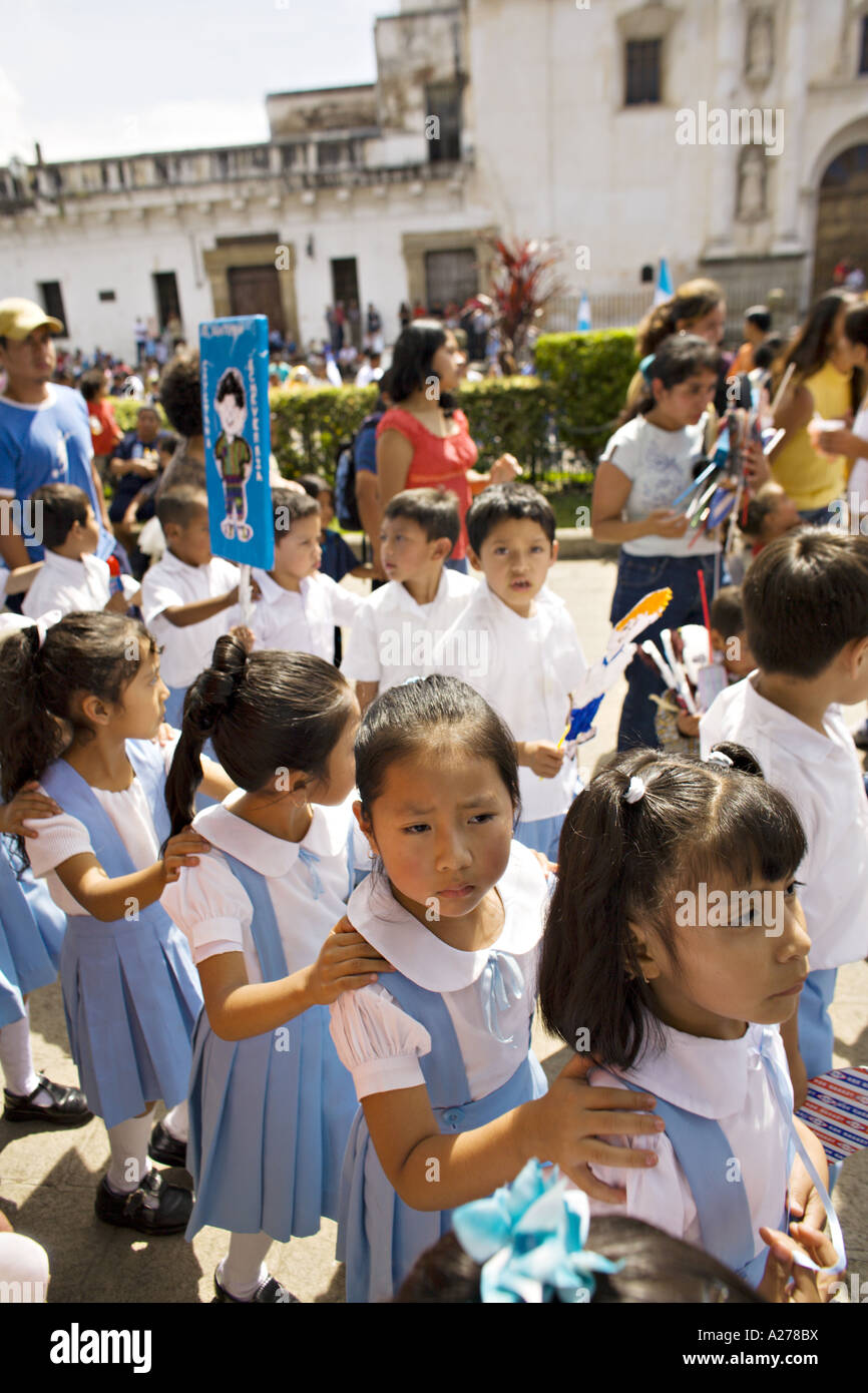 GUATEMALA ANTIGUA School children in uniform on a field trip for Independence Day hold each other s shoulders as they parade Stock Photo