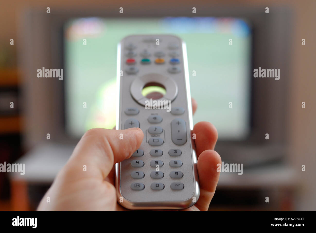 Hand with remote control Stock Photo Alamy