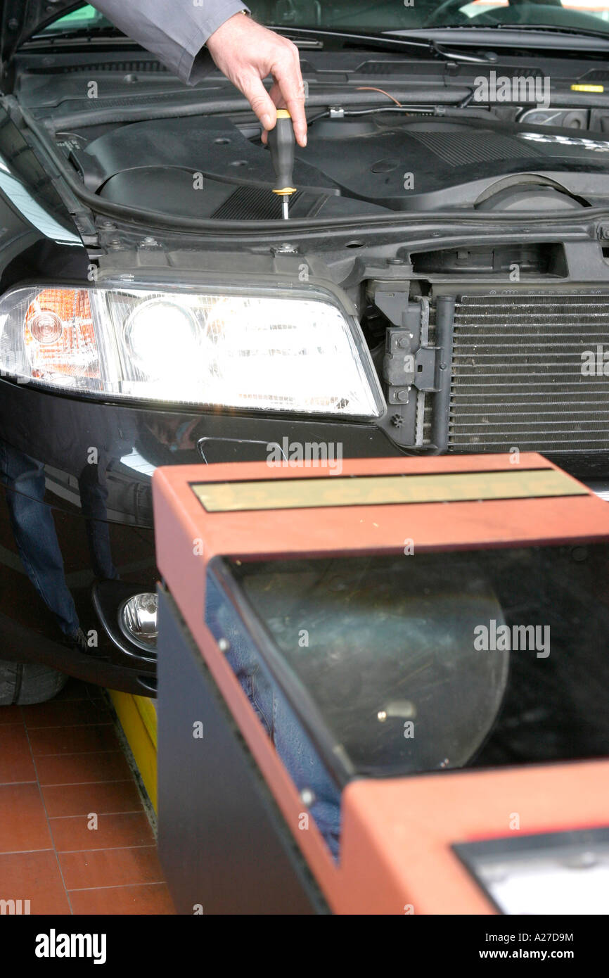 Adjustment of head lights in a garage Stock Photo