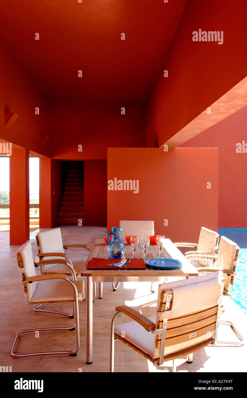 lunch table by a pool in a modern villa designed by architects Legorreta&Legorreta Stock Photo
