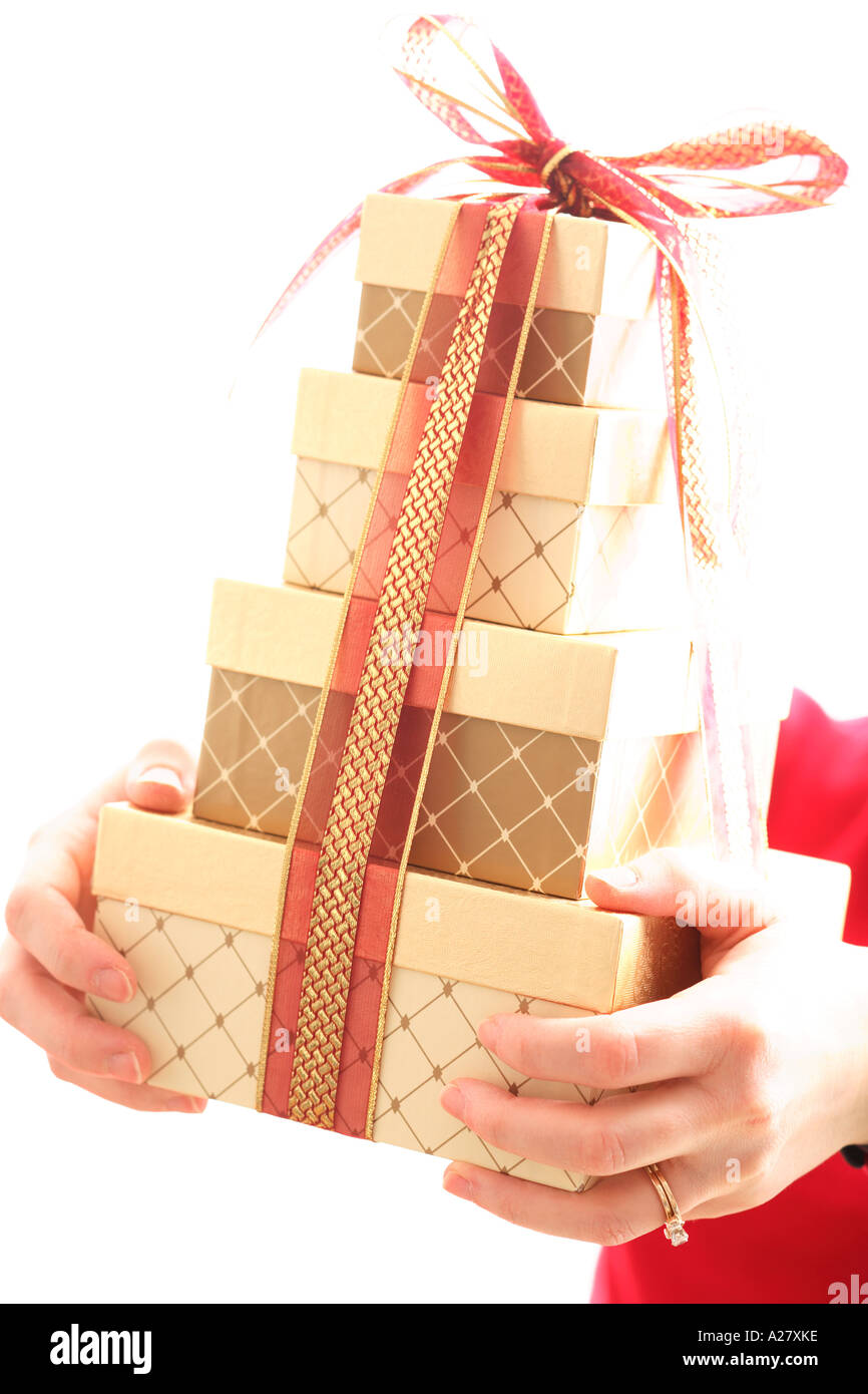 Hands holding stack of gifts with ribbon.  Selective soft focus effect. Stock Photo