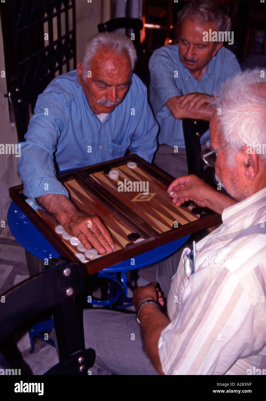Crete Greece Elderly men playing Tavli in Vrisses village Stock Photo