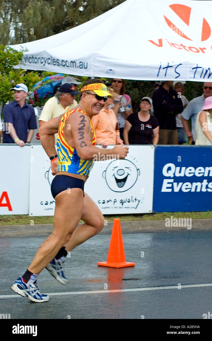A happy smiling man starts out in the running section of a triathlon, Noosa, Queensland, Australia. DSC 7831 Stock Photo