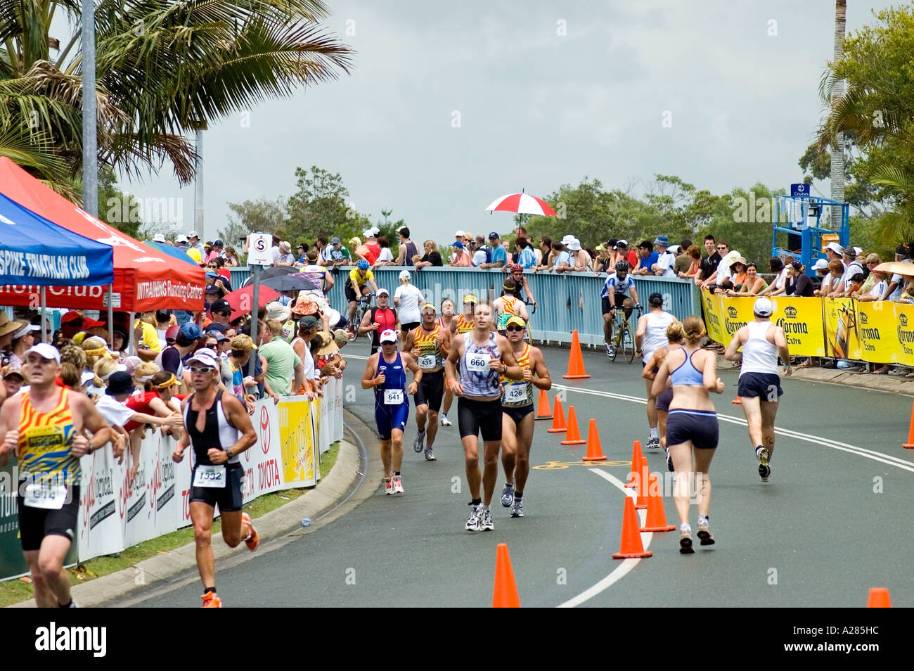 Men and women run to the finish of a triathlon, Noosa, Queensland, Australia. DSC 7843 Stock Photo